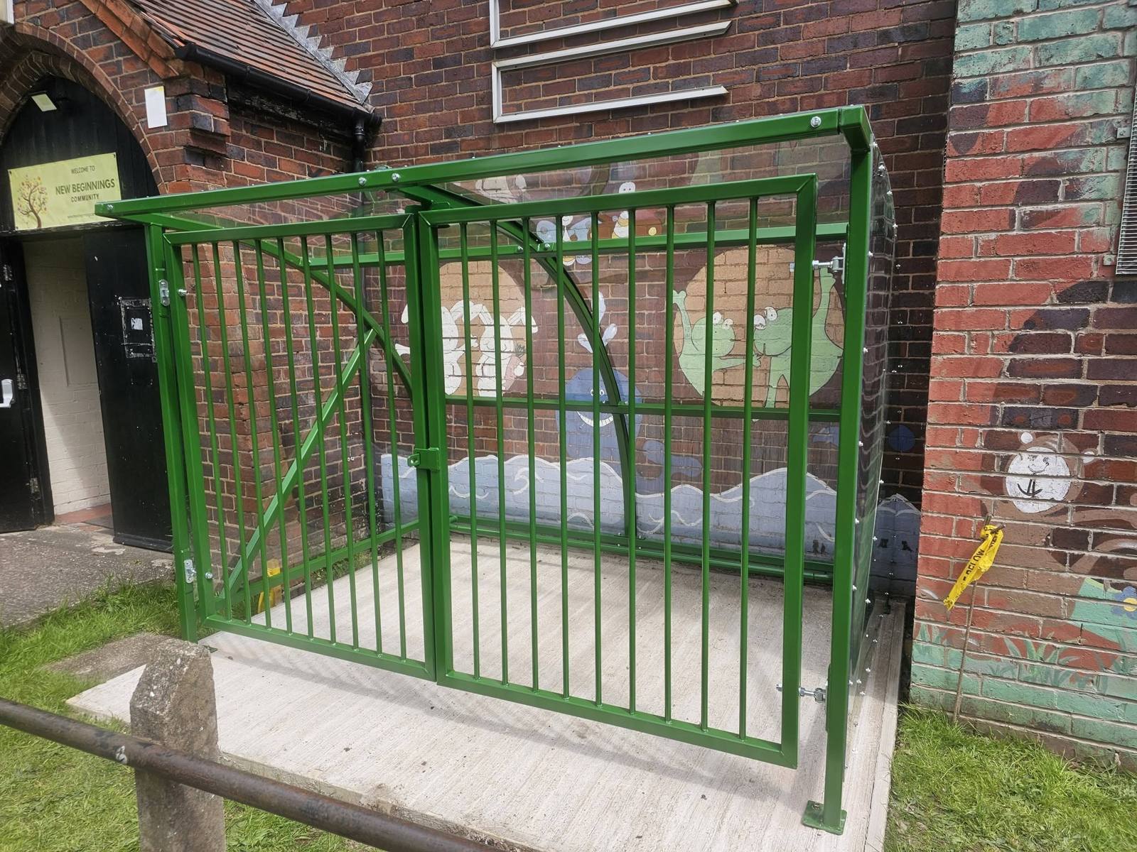 Buggy shelter with security gates, New Beginnings Creative, Birmingham, installed by Canopies & Shelters Ltd